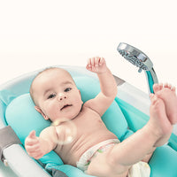 baby taking a bath on Babyhood Blue Bath Pad